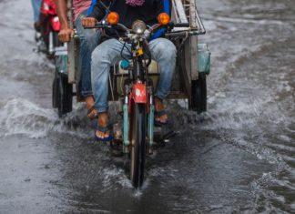 A Passenger Takes The Handlebars: A Small Act Of Bayanihan Amid Flooded Streets